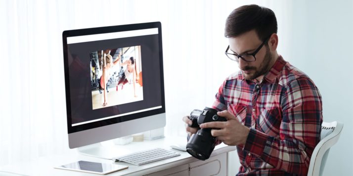 A photo of a man editing photos from his digital camera