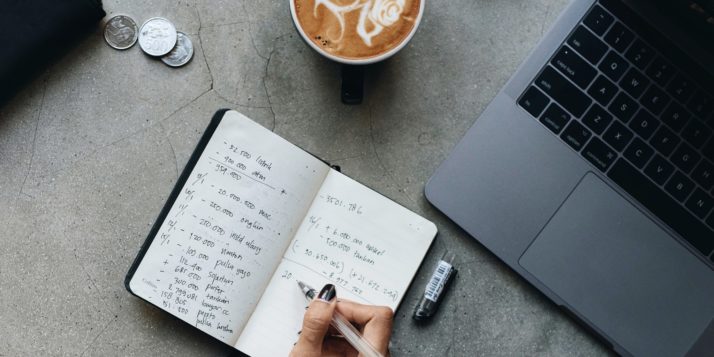 Man calculating taxes for his online store