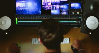 A business owner looks at a screen filled with different media to add to their website