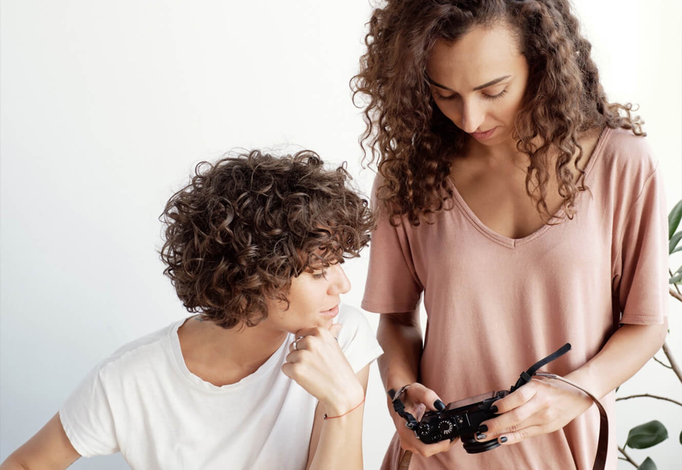 Two people in a photography studio review their pictures