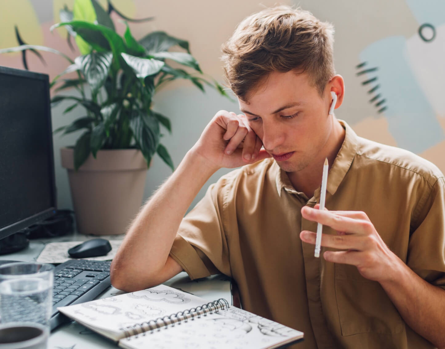 A self-employed person sitting at their desk trying to design a logo